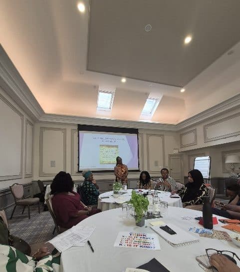 A small group around round tables at an ADI gathering in a hotel conference room